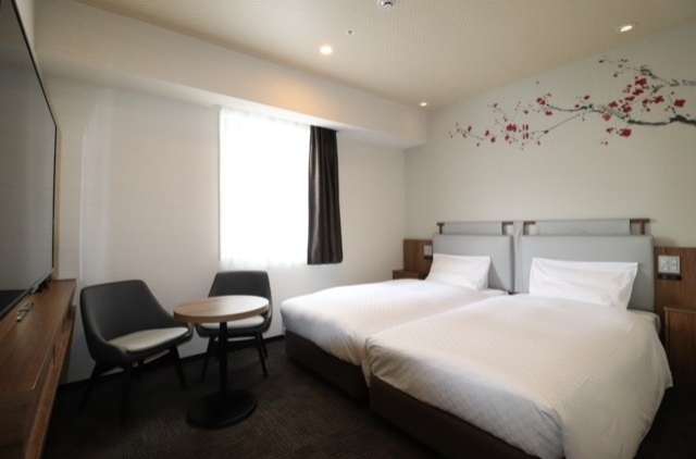 Two beds and desk of twin