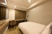 The bed and spacious desk in the Standard Single B room at Via Inn Shinagawa-Oimachi