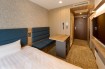 A bed and a sofa the Viainn Single Room at  Via Inn Shinagawa-Oimachi
