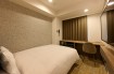 The bed and spacious desk in the Standard Single A room at Via Inn Shinagawa-Oimachi